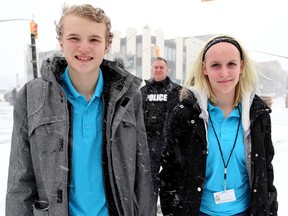 Dradon Hay and Savannah Paduch are hitting the streets with Belleville Police as part of the Youth In Policing Initiative After School Program. They are seen here downtown with Belleville Police Cst. Mark Hall.
Emily Mountney-Lessard/The Intelligencer