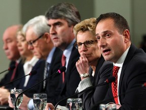 Prince Edward Island Premier Robert Ghiz (R) speaks during a news conference following a meeting of provincial and territorial premiers in Ottawa January 30, 2015. REUTERS/Chris Wattie