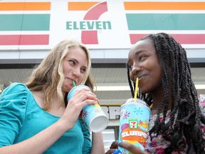 onja Rempel (left) and Rebecca Damtwe enjoy Slurpees at a Winnipeg 7-Eleven.