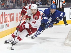 TORONTO, ON - JANUARY 29: Antoine Vermette #50 of the Arizona Coyotes skates away from a checking Mike Santorelli #25 of the Toronto Maple Leafs during an NHL game at the Air Canada Centre on January 29, 2015 in Toronto, Ontario, Canada.   Claus Andersen/Getty Images/AFP== FOR NEWSPAPERS, INTERNET, TELCOS & TELEVISION USE ONLY ==