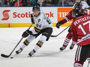 Chris Martenet of the London Knights clears a puck against Tyler Bertuzzi of the Guelph Storm. (AFP file photo)