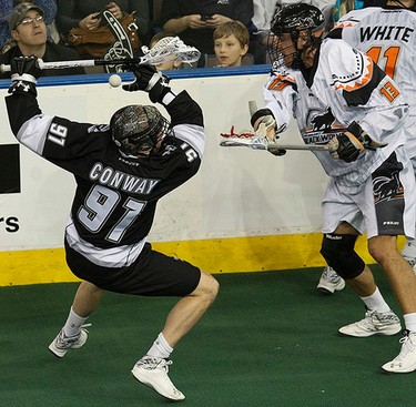 The Edmonton Rush's (97) is checked by the New England Black Wolves' Brett Manney (13) during first half NLL action at Rexall Place, in Edmonton Alta., on Friday Jan. 30, 2015. David Bloom/Edmonton Sun/QMI Agency