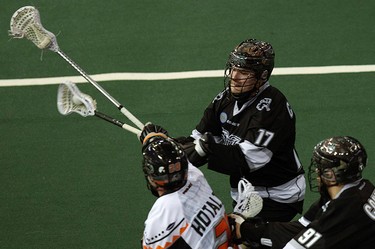 The Edmonton Rush's Robert Church (17) and Cory Conway (91) battle the New England Black Wolves' Ryan Hotaling (20) during first half NLL action at Rexall Place, in Edmonton Alta., on Friday Jan. 30, 2015. David Bloom/Edmonton Sun/QMI Agency