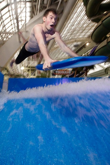 Lifeguard Jack Harris, 19,  jumps into the Tsunami FlowRider at West Edmonton Mall, in Edmonton Alta., on Friday Jan. 30, 2015. High volume pumps move 64,000 litres of water at 30 miles an hour to create a continuous sheet of flowing water, at the newly opened simulated surfing attraction. David Bloom/Edmonton Sun/QMI Agency