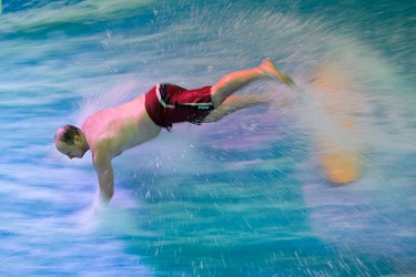 Ryan LeMay, 27, wipes out while riding the Tsunami FlowRider at West Edmonton Mall, in Edmonton Alta., on Friday Jan. 30, 2015. LeMay was unhurt. High volume pumps move 64,000 litres of water at 30 miles an hour to create a continuous sheet of flowing water, at the newly opened simulated surfing attraction. David Bloom/Edmonton Sun/QMI Agency