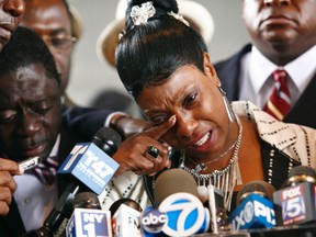 Constance Malcolm, right, mother of Ramarley Graham, speaks to the media next to Frank Graham, left, outside the Bronx Supreme Court in New York June 13, 2012. (REUTERS/Eduardo Munoz)