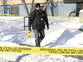 Ottawa police investigators comb the scene of a morning shooting Saturday, Jan. 31, 2015 on Morisset St. where one man was taken to hospital and several men taken into custody. Guns and Gangs detectives are leading the investigation into the city's third shooting of the year.
DOUG HEMPSTEAD/Ottawa Sun/QMI Agency