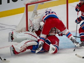 Washington Capitals forward Troy Brouwer runs over Montreal Canadiens goalie Carey Price during NHL play Saturday at the Bell Centre. (PIERRE-PAUL POULIN/QMI Agency)