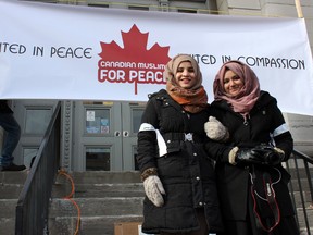 Friends Farah Hassoune (left), 17, and Sana Towheed, 17, who both attend KCVI, volunteered at the Canadian Muslims for Peace gathering a City Hall in Kingston, Ont. on Saturday January 31, 2015.  Steph Crosier/Kingston Whig-Standard/QMI Agency