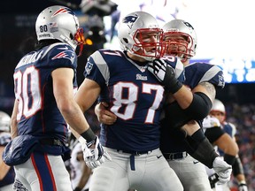 New England Patriots tight end Rob Gronkowski (87) celebrates with teammates after scoring a touchdown in the third quarter against the Baltimore Ravens during the 2014 AFC Divisional playoff football game at Gillette Stadium. (Greg M. Cooper-USA TODAY Sports)
