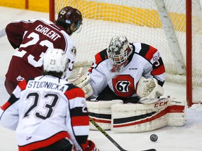 Peterborough Petes' Hunter Garlent fires the puck at Ottawa 67's goalie Leo Lazarev during first period OHL action at the Memorial Centre on Saturday, Jan. 31, 2015. Clifford Skarstedt/Peterborough Examiner/QMI Agency