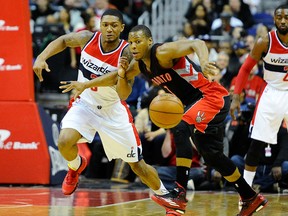 Wizards’ Bradley Beal (left) and Raptors Kyle Lowry battle for a loose ball on Saturday night at the Verizon Center in Washington. (USA TODAY SPORTS/PHOTO)
