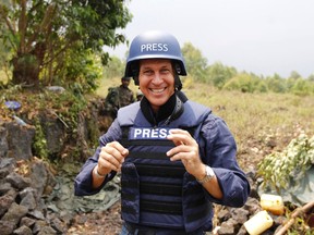 Al Jazeera journalist Peter Greste poses for a photograph in Kibati village, near Goma in the eastern Democratic Republic of Congo in this August 7, 2013 file photo. Greste, imprisoned in Egypt 400 days ago on charges that included aiding a terrorist group, will be deported to his native Australia on February 1, 2015, Egypt's state news agency reported.  REUTERS/Thomas Mukoya/Files