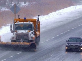 A snowplow clears Hwy. 401 on Sunday. Environment Canada has issued a winter storm warning for most of Southwestern Ontario, including London. MIKE HENSEN / THE LONDON FREE PRESS