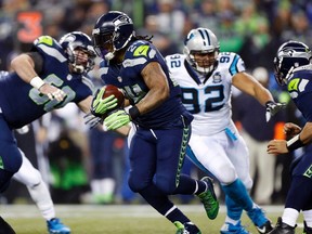 Seattle Seahawks running back Marshawn Lynch (24) runs the ball against the Carolina Panthers during the first half in the 2014 NFC Divisional playoff football game at CenturyLink Field. (Joe Nicholson-USA TODAY Sports)