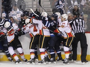 Players from the Winnipeg Jets and Calgary Flames shove each other in third period action in an NHL game at the MTS Centre on October 19, 2014 in Winnipeg, Manitoba, Canada. The teams meet again on Monday. (Marianne Helm/Getty Images/AFP file)