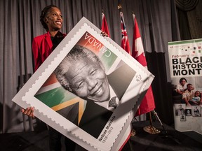 Canadian Olympic hurdler Phylicia George displays a Nelson Mandela stamp unveiled by Canada Post at the launch of Black History Month. (CRAIG ROBERTSON, Toronto Sun)