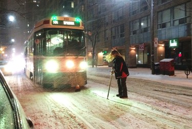 A Toronto Transit Commission (TTC) Streetcar is stopped in its track while the engineer attempts to clears snow on its path during a blizzard condition in Toronto, Ontario February 1, 2015. Southern Ontario is under Winter Storm with blizzard conditions with temperatures hovering at -14C. (REUTERS/Hyungwon Kang)