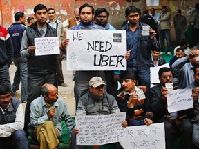 Uber taxi drivers hold placards during a protest against the ban on online taxi services, in New Delhi December 12, 2014. (REUTERS/Anindito Mukherjee)