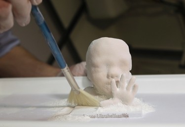 Haver Jarveoja cleans a three-dimensional (3D) print model of an unborn baby in Tallinn, Estonia, Jan. 28, 2015.   REUTERS/Ints Kalnins