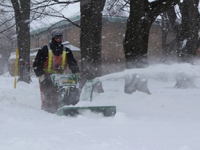 It was all hands on deck at the City of Sarnia Monday as crews worked to clear the heavy snowfall. Cory King, with the city's forestry department, was pitching in blowing snow off sidewalks along Wellington Street. (PAUL MORDEN, The Observer)