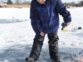 Ethan Klazinga, 8, of Wyoming, waits for a big catch at Sarnia Bay in this 2013 file photo. The Bluewater Anglers are holding their annual Ice Fishing Derby Feb. 14. (Observer file photo)