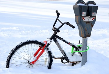 A bicycle is frozen in the snow in front of Victoria Park in London, Ont., February 2, 2015. (MORRIS LAMONT/QMI Agency)