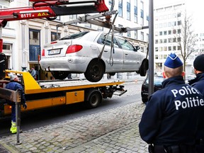 Belgian police officers stand guard as a car is removed near the EU Parliament in Brussels, Feb. 2, 2015. (FRANCOIS LENOIR/Reuters)