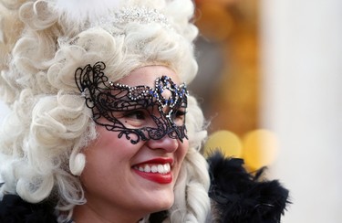 A masked reveller poses near Saint Mark's Square during the Venetian Carnival in Venice January 31, 2015. REUTERS/Stefano Rellandini
