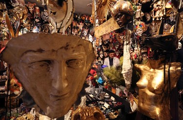 Iranian mask artisan Hamid works in his shop "Ca' del Sol" near St. Mark's square during the first day of carnival in Venice February 1, 2015. REUTERS/Stefano Rellandini