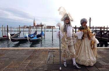 Revellers pose in front of St. Mark's square during the first day of carnival, in Venice February 1, 2015. REUTERS/Stefano Rellandini