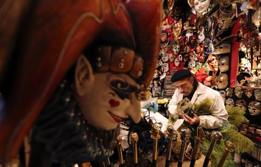 Iranian mask artisan Hamid works on a carnival mask in his shop "Ca' del Sol"  near St. Mark's square during the first day of carnival in Venice February 1, 2015. REUTERS/Stefano Rellandini