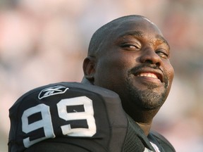 Oakland Raiders defender Warren Sapp laughs before their AFC-NFC Hall of Fame pre-season game against the Philadelphia Eagles in Canton, Ohio, in this August 6, 2006 file photo. (REUTERS/Matt Sullivan/Files)