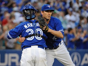 Toronto Blue Jays catcher Dioner Navarro (30) and relief pitcher Casey Janssen (44) celebrate the win against Baltimore Orioles at Rogers Centre. Blue Jays won 4-2. (Peter Llewellyn-USA TODAY Sports)