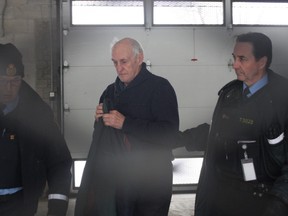 Robert Edgar, 78, leaves the L'Orignal courthouse escorted by OPP officers. He'll spend another week in custody, following a court appearance Monday. The Alfred man was charged with second-degree murder in the Jan. 25 death of his 83-year-old wife Zdenka Sykora.
COREY LAROCQUE/Ottawa Sun/Postmedia Network
