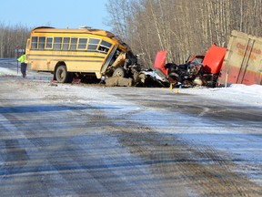 A 60-year-old school bus driver is dead -- and most of the 14 student-passengers are being treated for serious injuries -- after a collision with a semi truck near Grimshaw, Feb. 2, 2015. (Mile Zero News photo)