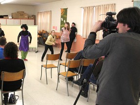 Tim Smith videotapes The Limestone Players Travelling Theatre Troupe as they perform a scene from their play Cinderfellow, which was being filmed for a documentary by an independent Ottawa filmmaker. (Michael Lea/Whig-Standard file photo)