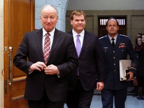 Canada's Defence Minister Rob Nicholson (left to right), Foreign Minister John Baird and Chief of Defence Staff General Tom Lawson arrive to testify before the Commons foreign affairs committee on Parliament Hill in Ottawa, Jan. 29, 2015. (CHRIS WATTIE/Reuters)