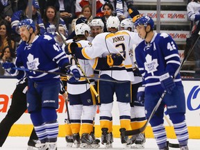 Leo Komarov (left) and Tyler Bozak skate away as Predators players celebrate one of the nine goals they scored at the Air Canada Centre back in November. (Stan Behal/Toronto Sun)