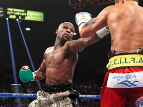 WBC/WBA welterweight champion Floyd Mayweather Jr. (left) of the U.S. jabs at  Marcos Maidana of Argentina during their title fight at the MGM Grand Garden Arena in Las Vegas, Nevada September 13, 2014. (REUTERS/Steve Marcus)