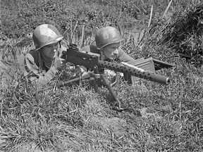 Men of the First Special Service Force (also known as the Devil's Brigade), Sergeant C.L. Sullivan (L) and Private Charles H. Prestwich, prepare with a Browning light machine gun at Anzio beachhead, Italy, in late April, 1944, in this handout photo courtesy of Canada's Department of National Defence. The unit, which will receive a Congressional Gold Medal in Washington on February 3, 2015, laid the foundation for modern-day special forces units in the United States and Canada.  REUTERS/Lieut. C.E. Nye/Canada's Department of National Defence/Library and Archives Canada/Handout