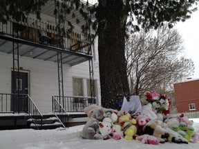 A woman and two children died after their Drummondville, Que., house burst into flames. Stuffed animals are pictured outside of the house on Feb. 2, 2015.  (MATHIEU DUGAS/QMI Agency)