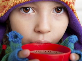 A youngster enjoys a “winter warmup” of hot chocolate during Family Day fun on the Toronto Waterfront. (Handout)