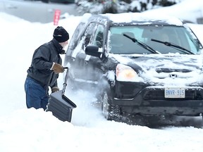 An Ottawa resident shovels snow after a overnight storm in Ottawa on Jan 30, 2015. Saint John, N.B. residents are doing a lot more shovelling after the city was hit with nearly 140 cm of snow in less than a week. (Tony Caldwell/QMI Agency)
