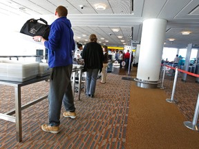 Passengers clear a Canadian Air Transport Security Authority (CATSA) security station at the Winnipeg James Armstrong Richardson International Airport.(Tom Braid/QMI Agency file photo)