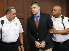Former New England Patriots star Aaron Hernandez is escorted by court officers as he enters Suffolk Superior Court before a hearing in Boston, Massachusetts, June 24, 2014. (REUTERS/Steven Senne/Pool)