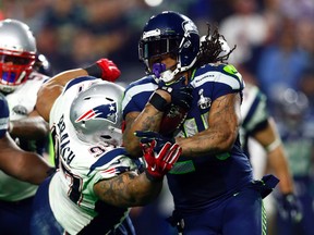 Seattle Seahawks running back Marshawn Lynch runs against New England Patriots nose tackle Alan Branch in the fourth quarter in Super Bowl XLIX at University of Phoenix Stadium on Feb. 1, 2015. (Mark J. Rebilas/USA TODAY Sports)