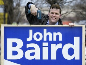 Conservative John Baird of the Ottawa-West-Nepean riding is seen putting a sign up in front of his campaign office on Merivale Rd. in 2005.