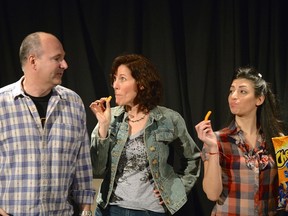 A confrontational moment in London Community Players? production of Michael Wilmot?s Buying The Moose has Steve Favro (Greg) tangling with Kathleen Morrison (Cheryl), centre, and Aleen Kelledjian (Betty). (Ross Davidson / Special to The Free Press)