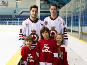 The Legionnaires Jr. 'B' club and Sarnia Minor Hockey will team up Saturday for the fourth annual Hockey Day in Sarnia event. Shown here, back row from left: Legionnaires Tyler Longo and Jake O'Donnell. Front row, same order: minor hockey players Carter Fawcett, Thomas Browning and Elizabeth Ballinger. (Submitted photo by Anne Tigwell)